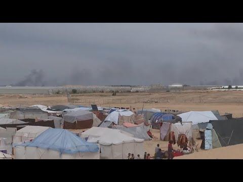 Smoke rises from Gaza Strip while displaced residents live in tents amid a constant struggle for foo