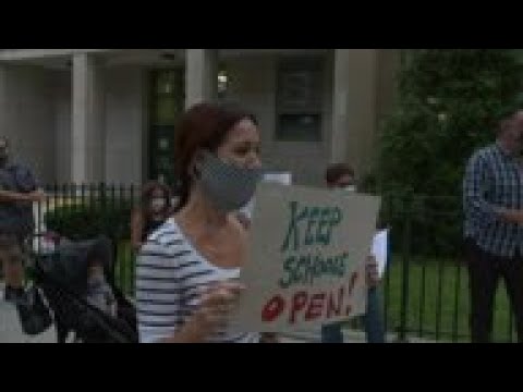 Parents protest school closures in virus spike areas