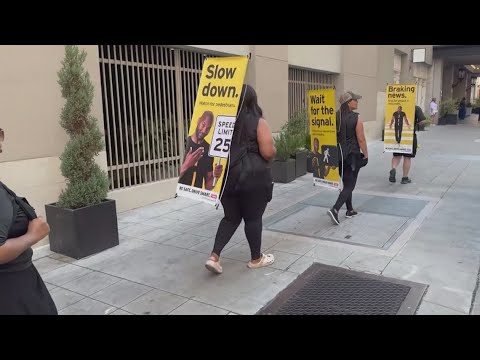 Walking billboards promote pedestrian safety