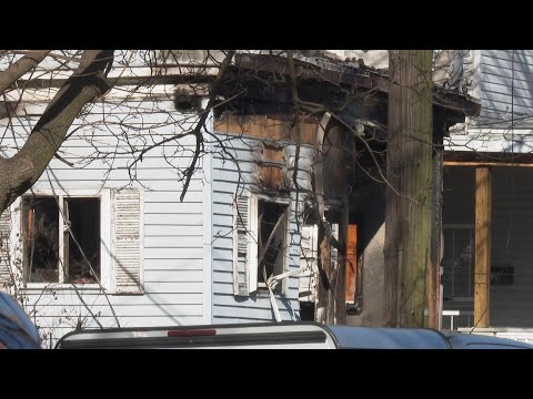 Search resumes at charred home after shootout and fire left 2 officers hurt and 6 people missing