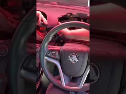 A rescue crew dismantle a car dashboard in search of a kitten