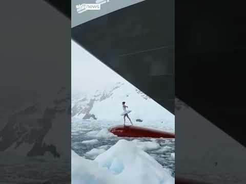 Ballerina dances on top of ship's bow