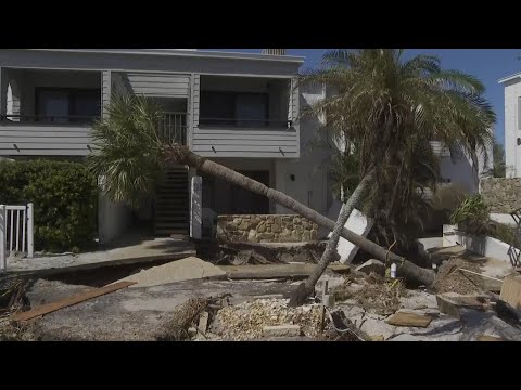 Residents clear debris in beachfront condos after Hurricane Milton tore through Florida