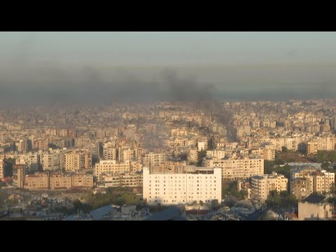 Smoke plumes rise over Beirut early in the morning