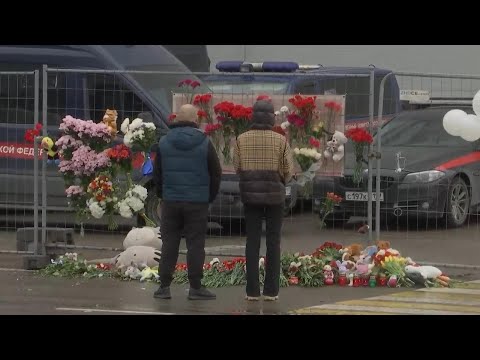 Survivor describes ordeal, mourners lay flowers at Moscow concert hall after terror attack