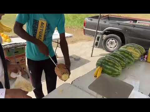 Fruit vendor Antonio peels a pineapple for Ian.. He's the best I've ever seen!!!