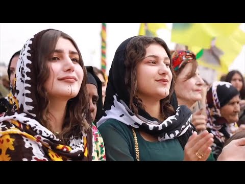 Hundreds of Syrian Kurds celebrate Newroz with bright costumes, dancing