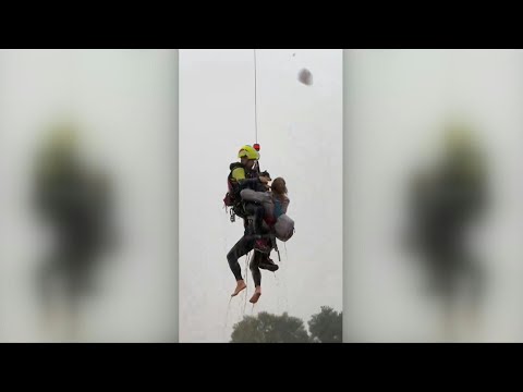 Dog owner rescued with pet from floods in Spain | AFP