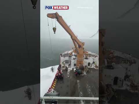 The U.S. Coast Guard Uses An Icebreaker Vessel To Rescue A Stranded Snowmobile Operator