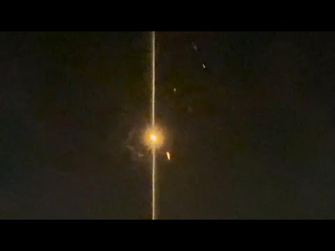 Iranian missiles or drones being intercepted in the sky above Jordan
