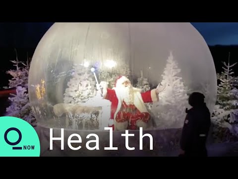 Santa Greets Children From Inside Giant Snow Globe at Denmark Zoo