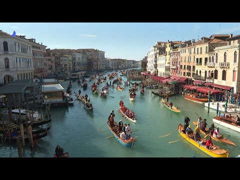 Confetti showered on huge carnival rat floating down Venice Grand Canal | AFP