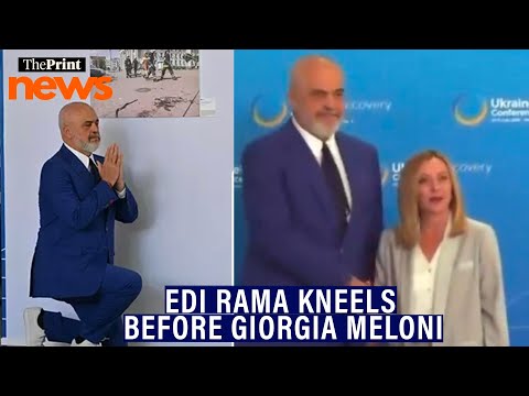 Albanian Prime Minister Edi Rama kneels before his Italian counterpart Giorgia Meloni
