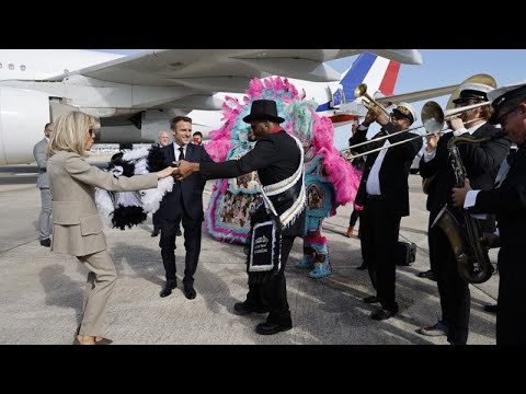 Emmanuel Macron tours New Orlean's French Quarter and is welcomed by locals