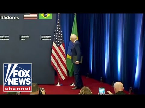 Biden almost takes out flag on way up to podium