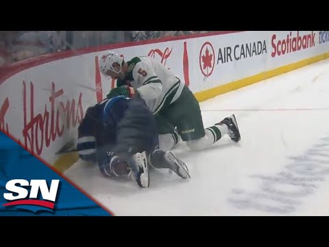 Jets Stanley drops glove with Wilds Middleton after collision on Scheifele