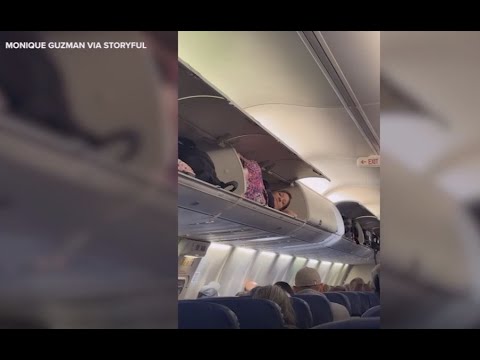 Woman Inside Overhead Luggage Compartment on Southwest Flight